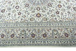 Corner detail of 2000s Kashan rug showing border pattern and Wool pile