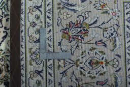 Backside of handmade 2000s Kashan rug showing knot structure and weave density