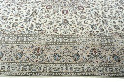 Corner detail of 2000s Kashan rug showing border pattern and Wool pile