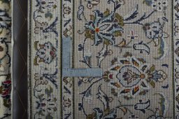 Backside of handmade 2000s Kashan rug showing knot structure and weave density