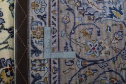 Backside of handmade 2000s Kashan rug showing knot structure and weave density