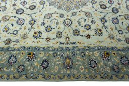 Corner detail of 2000s Kashan rug showing border pattern and Wool pile