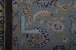 Backside of handmade 2000s Kashan rug showing knot structure and weave density