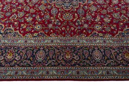 Corner detail of 2000s Kashan rug showing border pattern and Wool pile