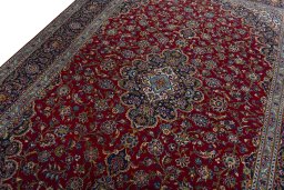 Backside of handmade 2000s Kashan rug showing knot structure and weave density