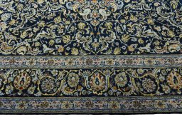 Corner detail of 2000s Kashan rug showing border pattern and Wool pile