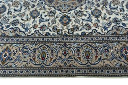 Corner detail of 2000s Kashan rug showing border pattern and Wool pile