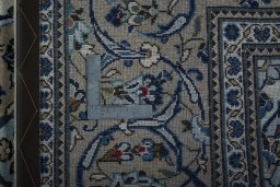 Backside of handmade 2000s Kashan rug showing knot structure and weave density