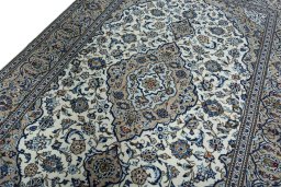 Backside of handmade 2000s Kashan rug showing knot structure and weave density