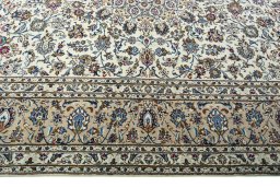 Corner detail of 2000s Kashan rug showing border pattern and Wool pile