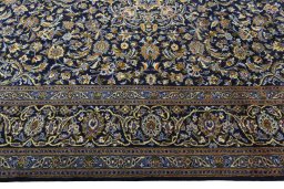 Corner detail of 2000s Kashan rug showing border pattern and Wool pile