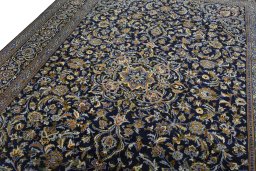 Backside of handmade 2000s Kashan rug showing knot structure and weave density