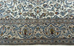 Corner detail of 2000s Kashan rug showing border pattern and Wool pile