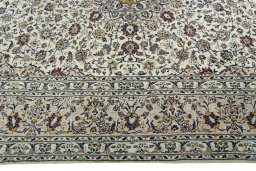 Corner detail of 2000s Kashan rug showing border pattern and Wool pile