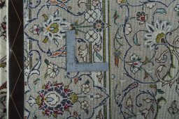 Backside of handmade 2000s Kashan rug showing knot structure and weave density