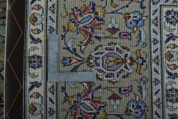 Backside of handmade New Kashan rug showing knot structure and weave density