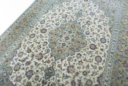 Backside of handmade New Kashan rug showing knot structure and weave density