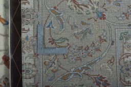Backside of handmade New Kashan rug showing knot structure and weave density