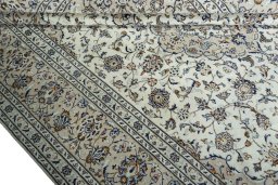 Corner detail of 2000s Kashan rug showing border pattern and Wool pile