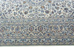 Corner detail of 2000s Kashan rug showing border pattern and Wool pile