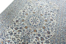 Backside of handmade 2000s Kashan rug showing knot structure and weave density