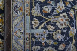 Backside of handmade 1970s Kashan rug showing knot structure and weave density