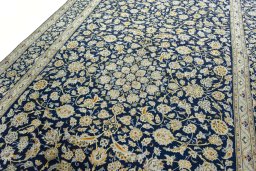 Backside of handmade 1970s Kashan rug showing knot structure and weave density