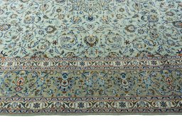 Corner detail of 2000s Kashan rug showing border pattern and Wool pile