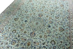 Backside of handmade 2000s Kashan rug showing knot structure and weave density