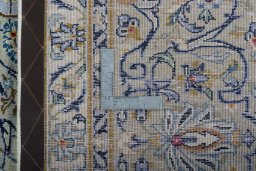 Backside of handmade 2000s Kashan rug showing knot structure and weave density