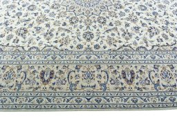 Corner detail of 2000s Kashan rug showing border pattern and Wool pile