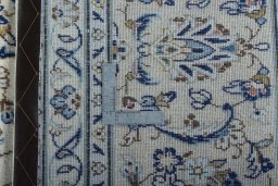 Backside of handmade 2000s Kashan rug showing knot structure and weave density