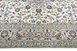 Corner detail of 2000s Kashan rug showing border pattern and Wool pile