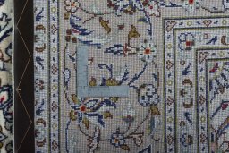 Backside of handmade 2000s Kashan rug showing knot structure and weave density