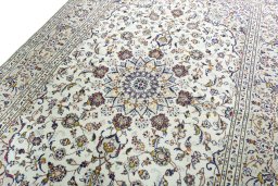 Backside of handmade 2000s Kashan rug showing knot structure and weave density