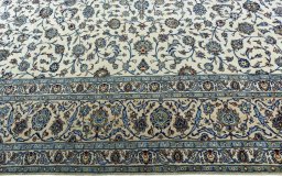 Corner detail of 2000s Kashan rug showing border pattern and Wool pile