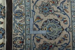 Backside of handmade 2000s Kashan rug showing knot structure and weave density