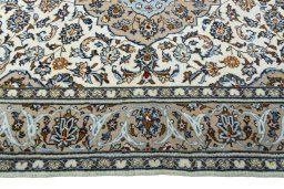 Corner detail of 2000s Kashan rug showing border pattern and Wool pile