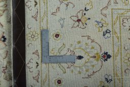 Backside of handmade New Kashan rug showing knot structure and weave density