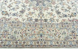 Corner detail of 2000s Kashan rug showing border pattern and Wool pile