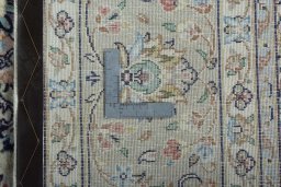 Backside of handmade 2000s Kashan rug showing knot structure and weave density