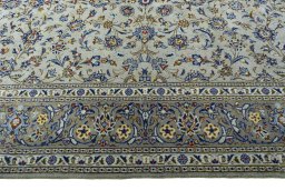 Corner detail of 2000s Kashan rug showing border pattern and Wool pile