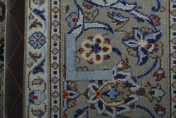 Backside of handmade 2000s Kashan rug showing knot structure and weave density