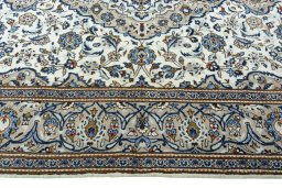 Corner detail of 2000s Kashan rug showing border pattern and Wool pile
