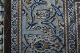 Backside of handmade 2000s Kashan rug showing knot structure and weave density