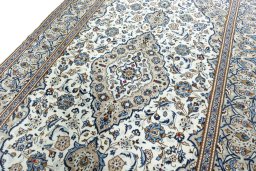 Backside of handmade 2000s Kashan rug showing knot structure and weave density
