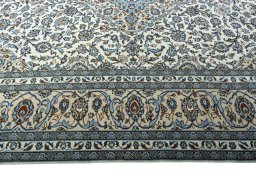 Corner detail of 2000s Kashan rug showing border pattern and Wool pile