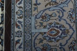 Backside of handmade 2000s Kashan rug showing knot structure and weave density