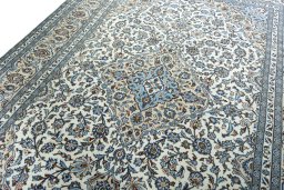 Backside of handmade 2000s Kashan rug showing knot structure and weave density