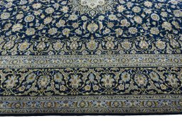 Corner detail of 2000s Kashan rug showing border pattern and Wool pile